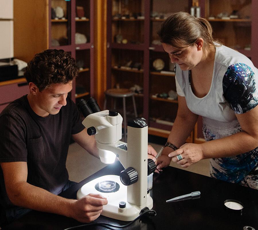 a biology student using a microscope in a laboratory